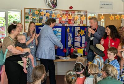A group of parents and young children at a Family Hub, with Councillor Andrew Leadbetter