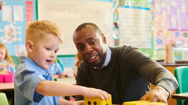 Young child at school with teacher