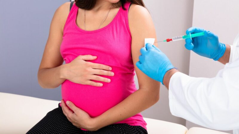 A pregnant woman having a vaccination