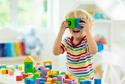 A young boy playing with building bricks