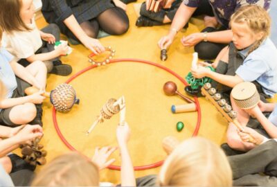 A group of primary school age children sat in a circle playing