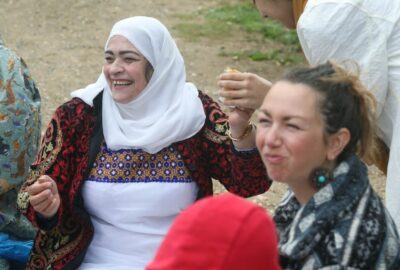 A group of women sat together smiling and laughing
