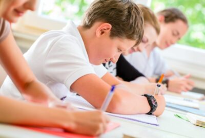 A group of secondary school pupils sat at their desks working