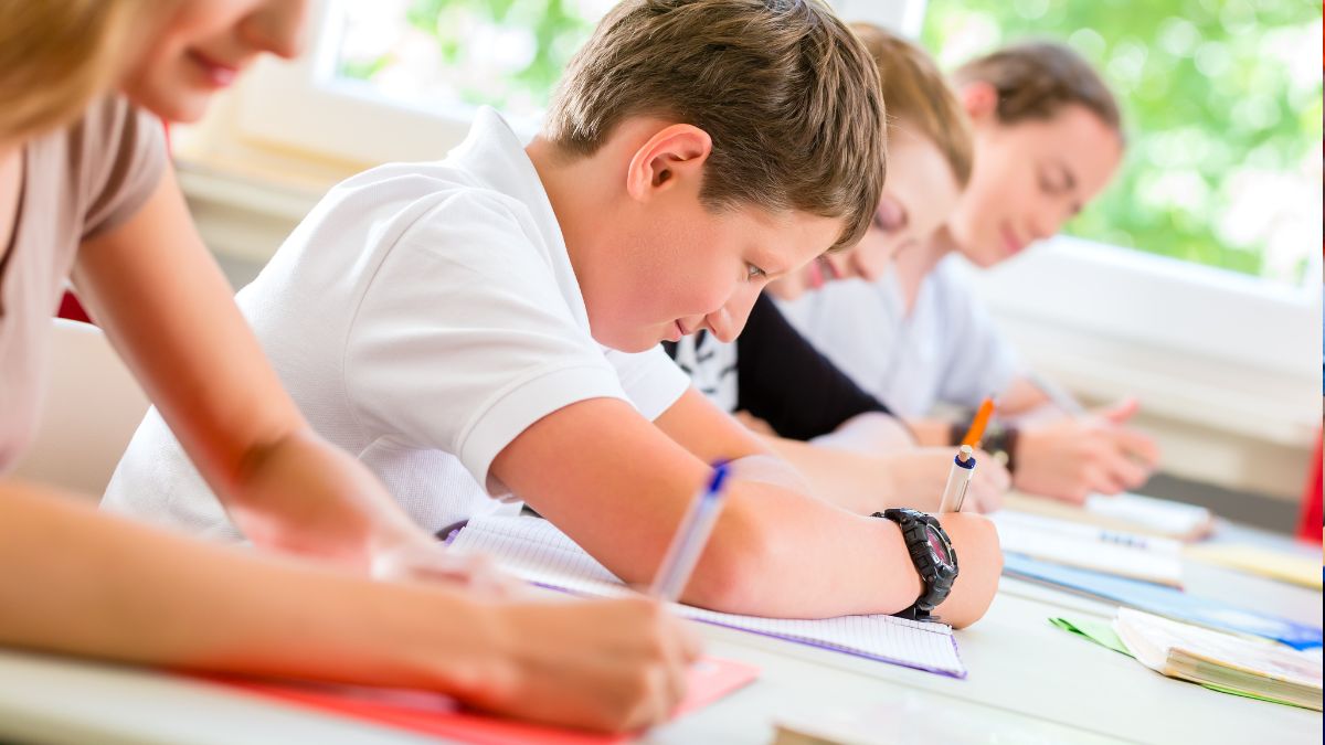 A group of secondary school pupils sat at their desks working