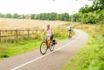Two cyclists cycling along a cycle path