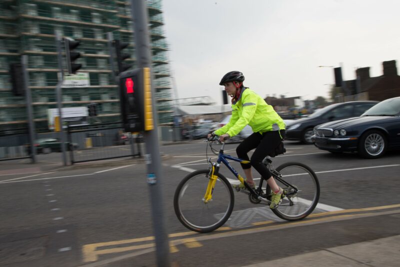 Cyclist wearing hi-vis in traffic