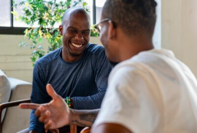 Two people at work chatting and smiling