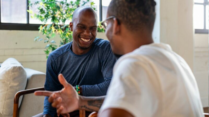 Two people at work chatting and smiling