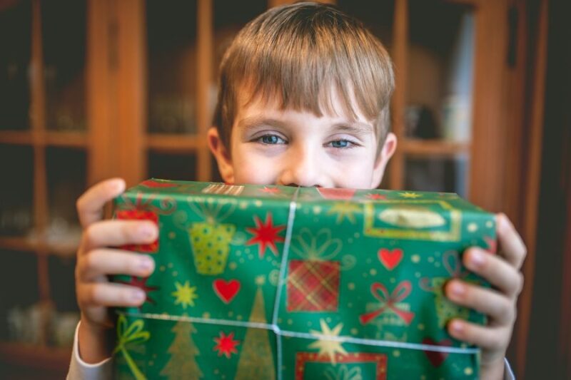 Young boy holding a Christmas present