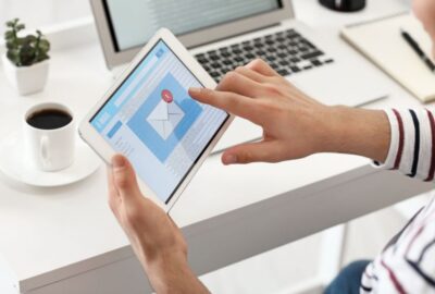 Hands on an ipad opening an email