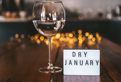 A wine glass containing water or lemonade, and a sign reading 'dry january'