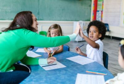 teacher in classroom with children learning