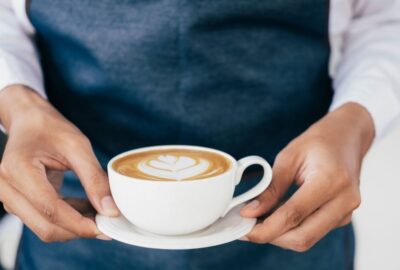 A waitress in a cafe (not Nia, referred to in this story) serving a cup of coffee to a customer