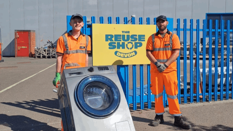 Two SUEZ staff with a washing machine