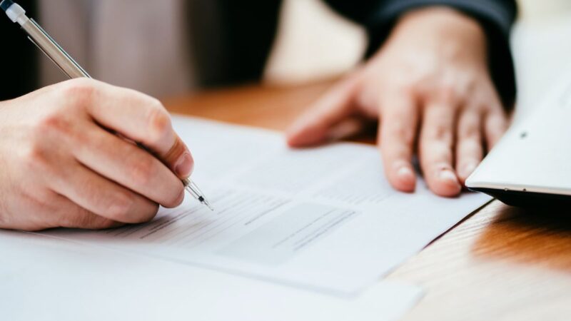 A person completing a written form