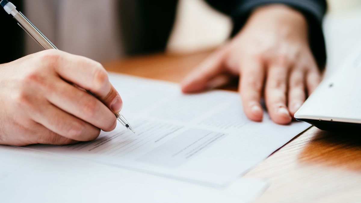 A person completing a written form