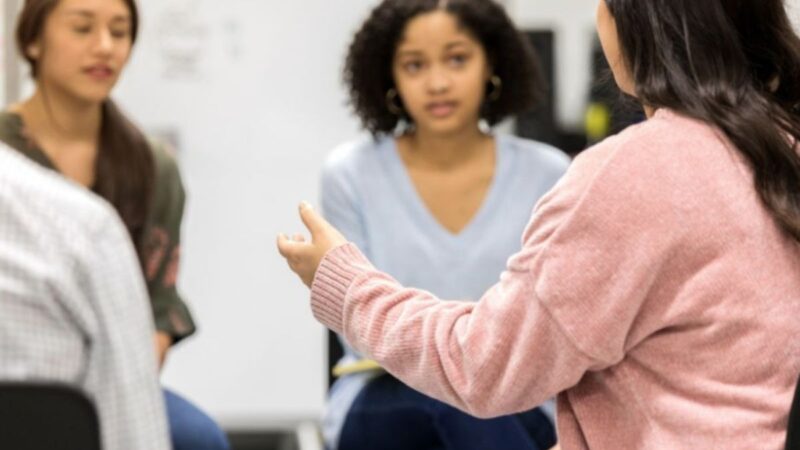 Three people talking in a group