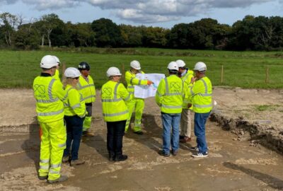 Invited guests gather in high-vis clothing and hard hats, for a briefing as the work starts.