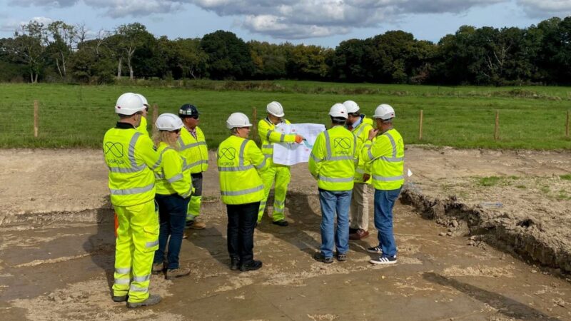 Invited guests gather in high-vis clothing and hard hats, for a briefing as the work starts.