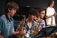 Three young people playing saxophone on stage