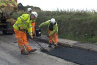 Highways teams repairing a road