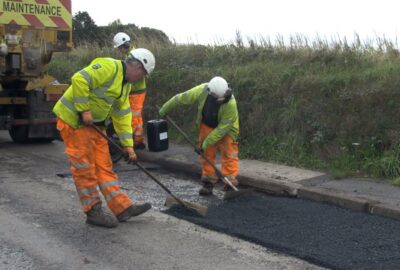 Highways teams repairing a road