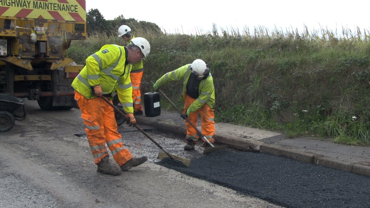 Highways teams repairing a road