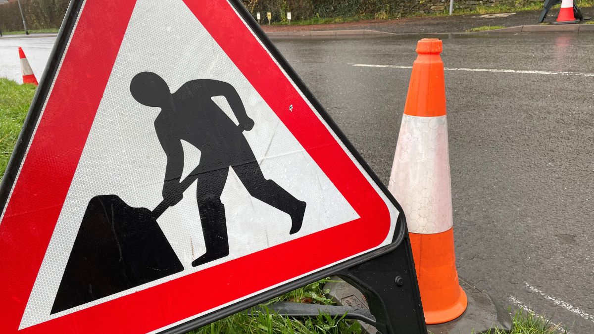 Roadworks sign and traffic cone