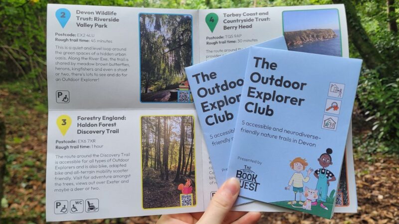 Two hands holding the outdoor explorers book leaflet