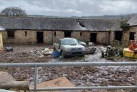 The farm yard at Crook Farm, covered in slurry waste. Outbuildings appear neglected. No animals in the photograph