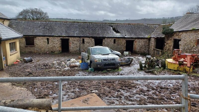 The farm yard at Crook Farm, covered in slurry waste. Outbuildings appear neglected. No animals in the photograph