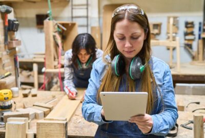 A young person learning a trade in a wood working workshop