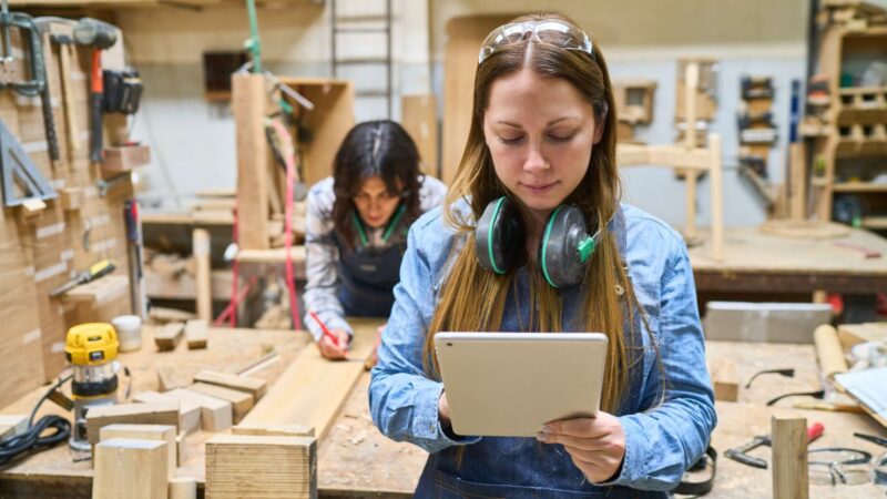 A young person learning a trade in a wood working workshop