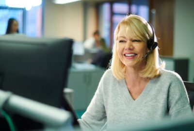 A customer service worker on the telephone to a customer