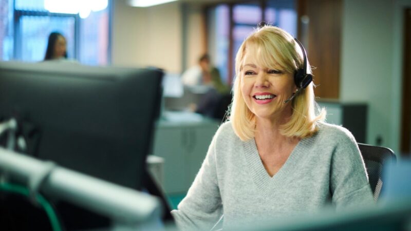 A customer service worker on the telephone to a customer