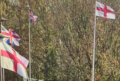 CCTV image of flags flying from the top of streetlights
