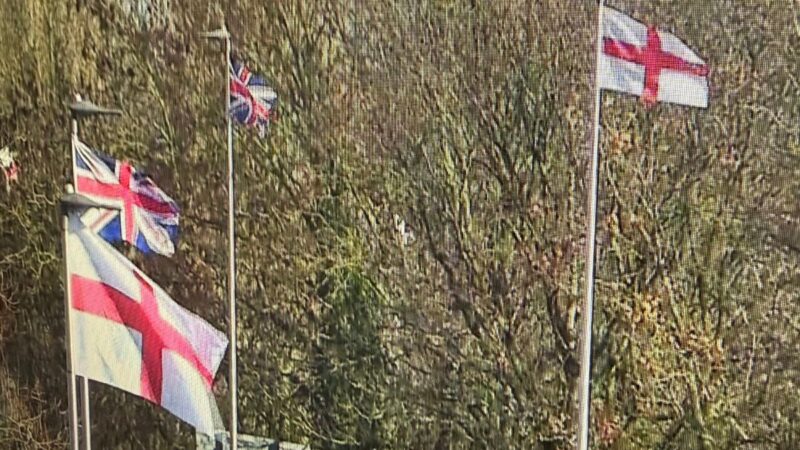 CCTV image of flags flying from the top of streetlights
