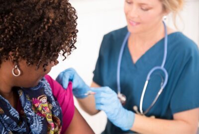 Women receiving vaccination from a healthcare professional