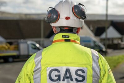 A Wales & West Utilities engineer, wearing a flourescent jacket with 'Gas' written on the back of it.