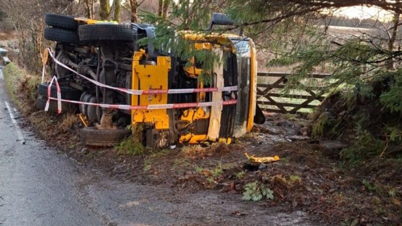 A gritter vehicle turned over on its side having skidded on ice