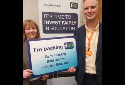 Councillors Bickley and Jefferies holding a sign that reads 'I'm backing fairer funding' campaign