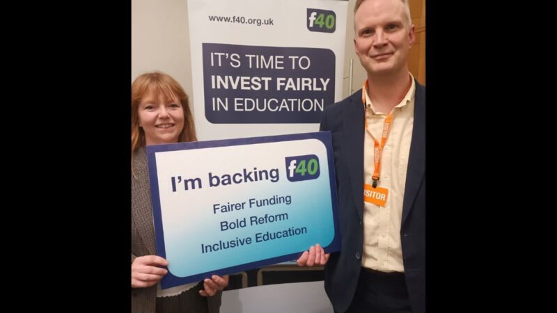 Councillors Bickley and Jefferies holding a sign that reads 'I'm backing fairer funding' campaign