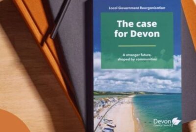 The LGR document entitled The Case For Devon. The document is resting on the top of a pile of books and folders