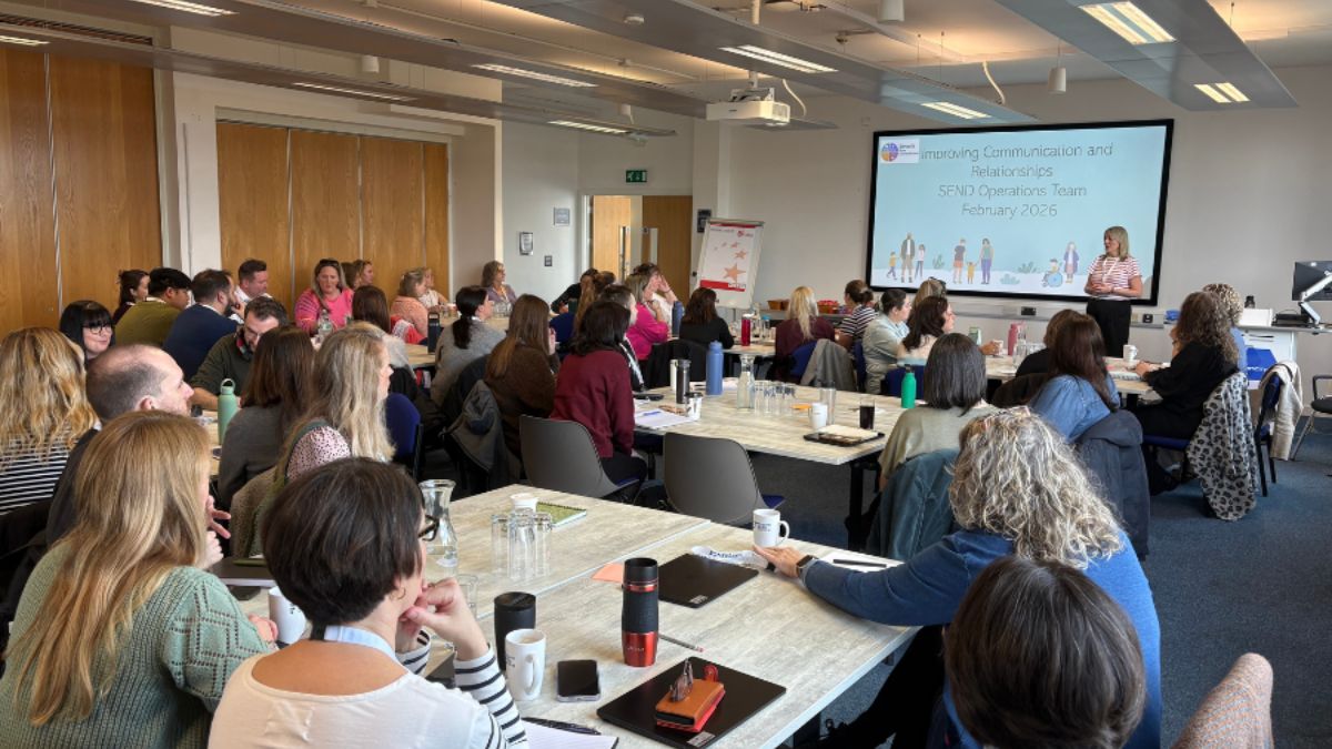 A group of people sat around tables at a conference