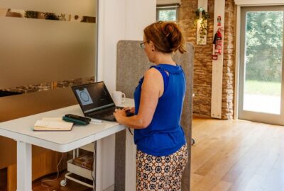 Woman working at a standing desk at The Tribe