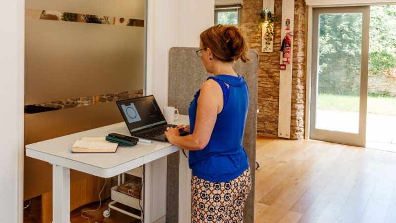 Woman working at a standing desk at The Tribe