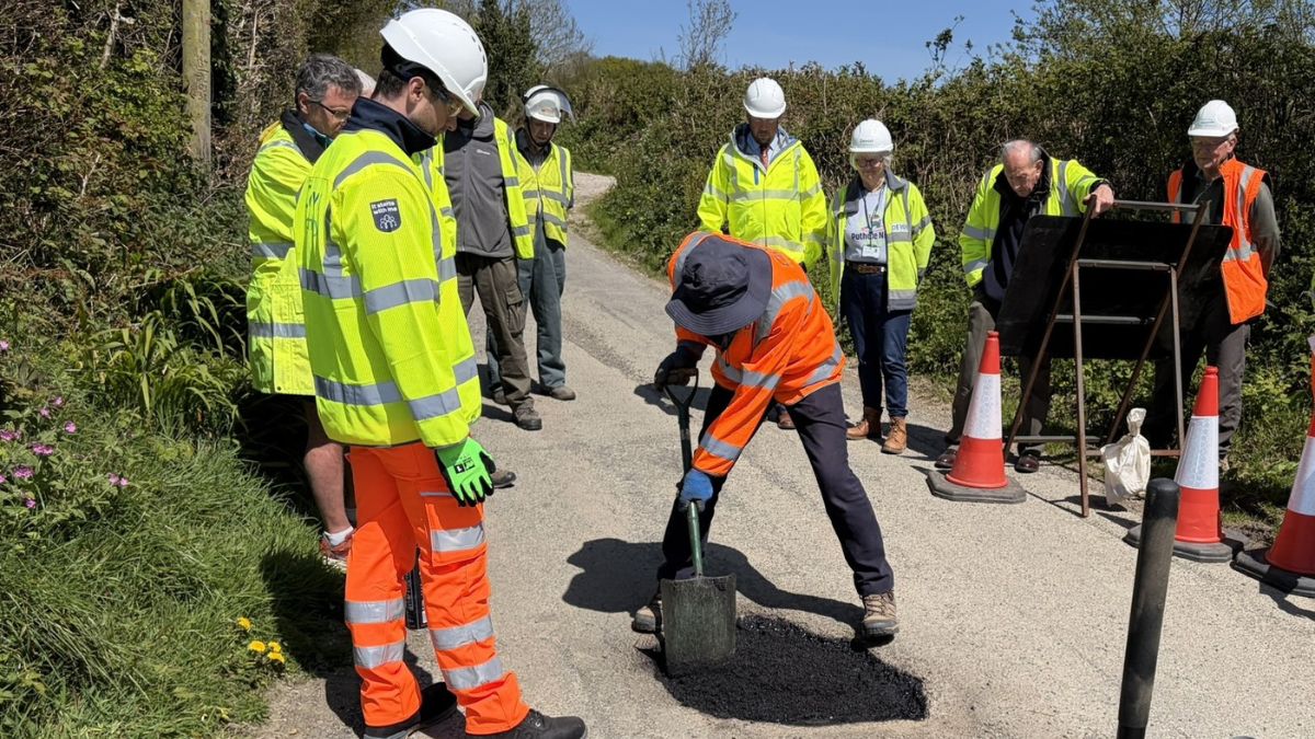 Road warden repairing a pothole