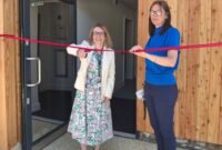 Councillor Jess Bailey officially opens the new facility at Mill Water School. Cllr Bailey is cutting a ribbon. Head Teacher, Sarah Pickering is stood by Cllr Bailey.
