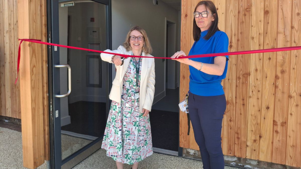Councillor Jess Bailey officially opens the new facility at Mill Water School. Cllr Bailey is cutting a ribbon. Head Teacher, Sarah Pickering is stood by Cllr Bailey.
