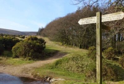 A signpost on Dartmoor indicating a walking route across the moor
